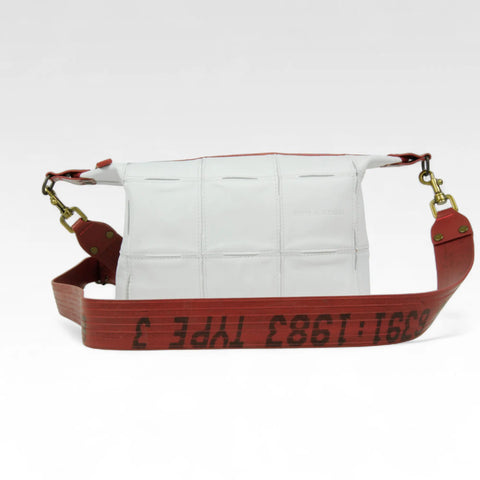 The Elvis & Kresse Boho Bag, available in white upcycled leather and red recycled fire-hose