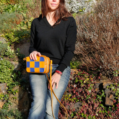The Elvis & Kresse Disco Bag, available in pink, black, blue and yellow upcycled leather and yellow recycled fire-hose