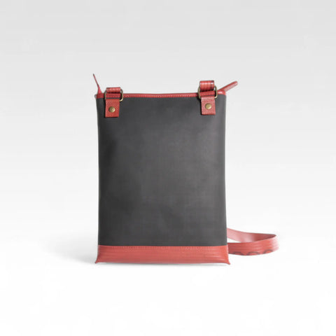 The Elvis & Kresse Reporter bag, a small crossbody messenger bag made from recycled materials