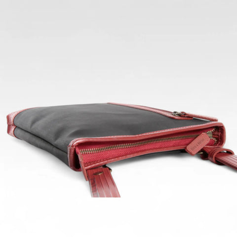 The Elvis & Kresse Reporter bag, a small crossbody messenger bag made from recycled materials