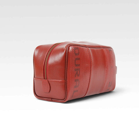 The Elvis & Kresse Large Washbag, available in red recycled fire-hose