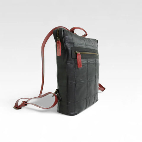The Elvis & Kresse Small Backpack, available in cognac upcycled leather and red recycled fire-hose