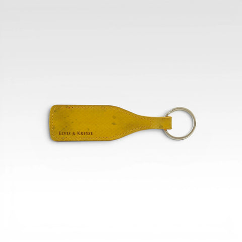 The Elvis & Kresse Wine bottle key ring, available in yellow recycled fire-hose