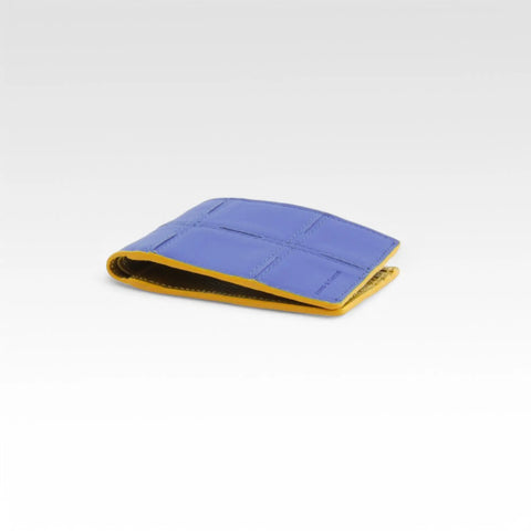 The Elvis & Kresse Compact Leather Wallet, available in cobalt blue upcycled leather and yellow recycled fire-hose