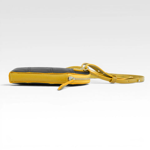 The Elvis & Kresse Crossbody Pouch, available in black upcycled leather and yellow recycled fire-hose