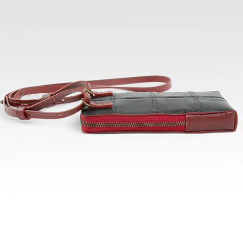 The Elvis & Kresse Crossbody Pouch, available in black upcycled leather and red recycled fire-hose