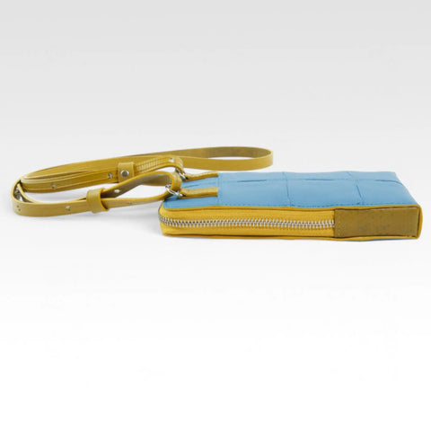 The Elvis & Kresse Crossbody Pouch, available in blue upcycled leather and yellow recycled fire-hose
