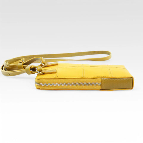 The Elvis & Kresse Crossbody Pouch, available in yellow upcycled leather and yellow recycled fire-hose