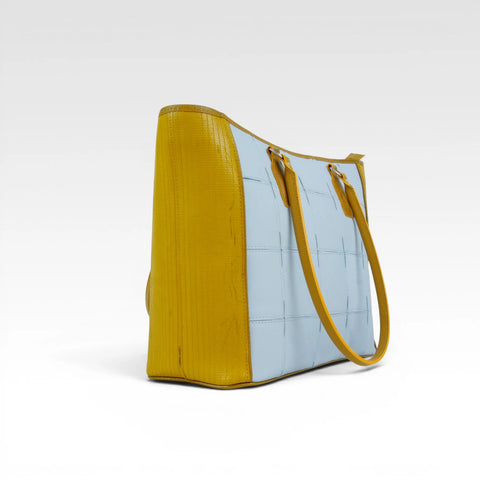 The Elvis & Kresse Classic Tote Bag, available in pale blue upcycled leather and yellow recycled fire-hose