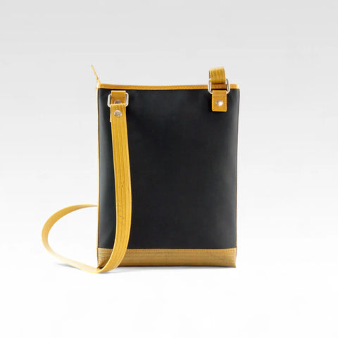 The Elvis & Kresse Reporter bag, a small crossbody messenger bag made from recycled materials