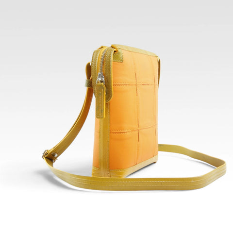 The Elvis & Kresse Saddle Bag, available in grey upcycled leather and yellow recycled fire-hose