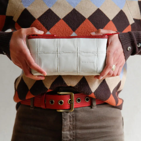 The Elvis & Kresse Toiletry Pouch made with hand woven rescued leather and upcycled fire-hose