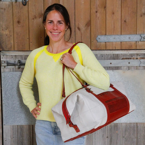 The Elvis & Kresse Weekend Bag, available in light grey upcycled leather and red recycled fire-hose